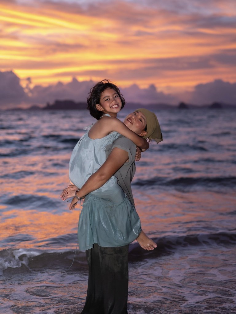 Family beach photography in Krabi with natural smiles, candid moments, and beautiful sunset scenery.